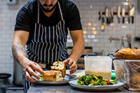Chef artfully plating seasonal ingredients.