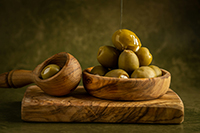 Golden olive oil drizzled over fresh harvest.